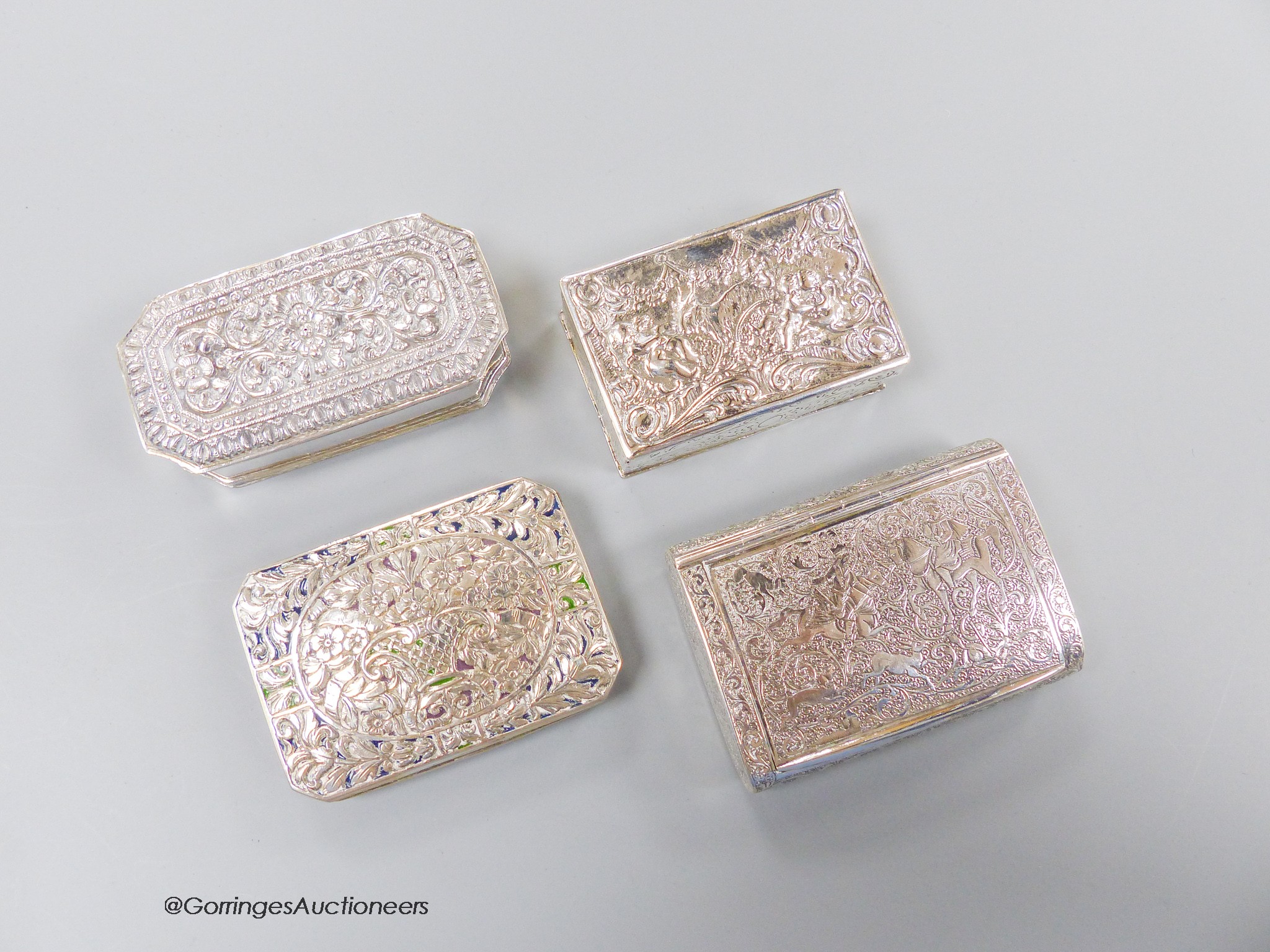 Four assorted 20th century continental white metal snuff boxes, including Middle Easter and one with plique a jour lid, largest 85mm, gross weight 11.6oz.